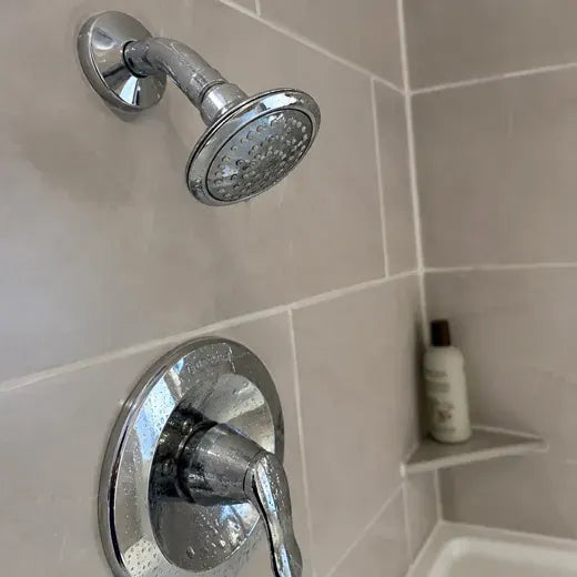 Chrome shower head and fixture with hard-water marks